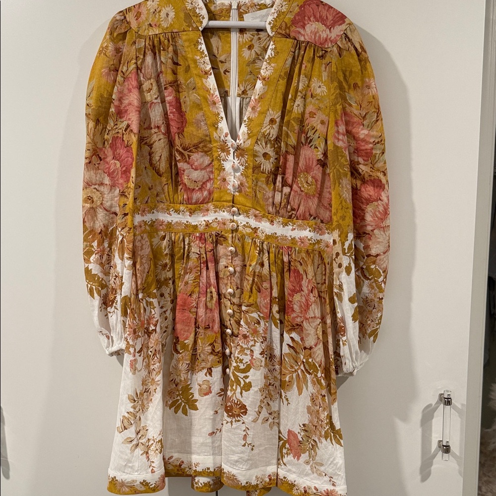 Zimmerman Pattie floral-print linen mini dress in a mustard yellow color.